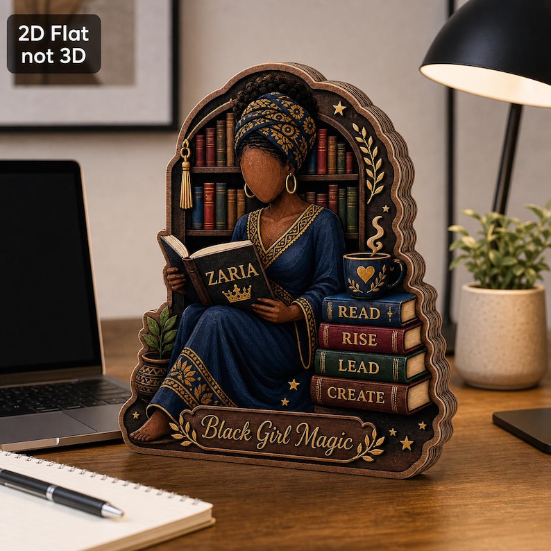 May include: A 2D flat wooden decorative cutout featuring a person wearing a blue robe and headwrap, reading a book labeled ZARIA. Beside them is a stack of books labeled READ, RISE, LEAD, CREATE, and a mug. The base text reads Black Girl Magic.