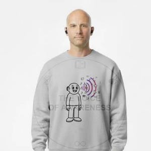 May include: A light gray sweatshirt with a cartoon figure and the text "VOICE OF AWARENESS". The sweatshirt is paired with khaki pants and white sneakers. The person is wearing black earbuds.