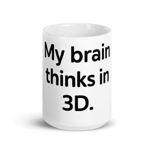 May include: A white ceramic mug featuring the black printed text My brain thinks in 3D. The mug has a cylindrical shape with a smooth finish and a standard handle, displaying the text clearly on the front surface against the white background.