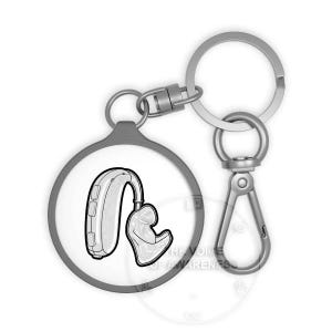 May include: A silver keychain with a round pendant featuring a black and white illustration of a hearing aid. The keychain has a clasp and a split ring for attaching keys. The text "THE VOICE OF AWARENESS" is visible.