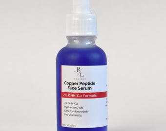 May include: A blue glass dropper bottle containing Copper Peptide Face Serum with a 2% GHK-Cu formula. The white label displays the Redline logo, ingredients including Hyaluronic Acid, Dimethyl Isosorbide, and Pro-vitamin B5, and states 1 fl oz U.S.