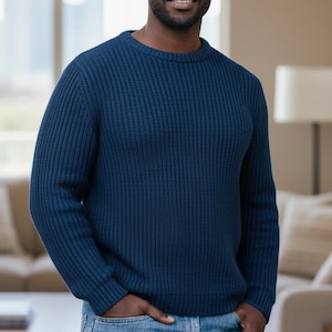 May include: A navy blue ribbed knit sweater with a crew neck. The sweater has a textured pattern and is made of a soft material. The sleeves are long, and the fit is regular.