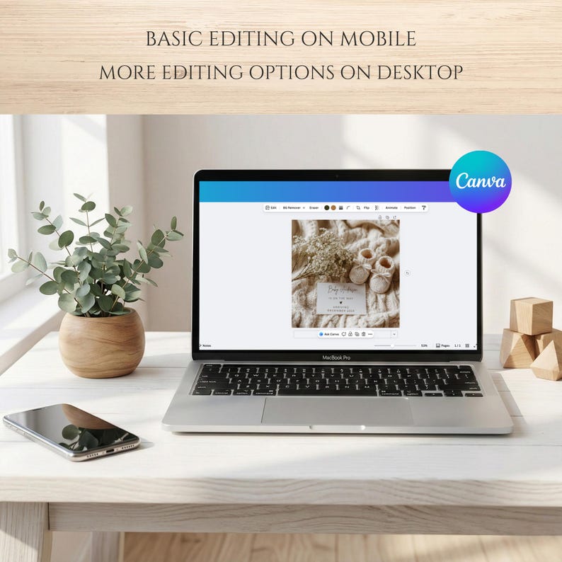 May include: A laptop displaying a baby shower invitation design, with the Canva logo in the corner. The laptop sits on a light-colored wooden table, next to a potted plant and a smartphone. Text at the top reads: "BASIC EDITING ON MOBILE MORE EDITING OPTIONS ON DESKTOP."