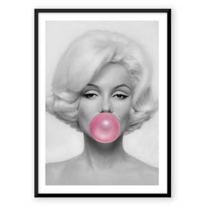 Peut inclure: Un portrait encadré en noir et blanc représentant une personne aux cheveux blonds volumineux soufflant une grande bulle de chewing-gum rose vif et ronde. Le sujet a un grain de beauté sur la joue et est centré dans un cadre noir simple.