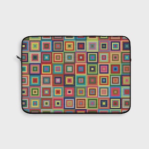 May include: A laptop sleeve with a colorful patchwork design. The pattern features squares in various colors, including red, yellow, blue, and green, arranged in a grid. The sleeve has a black border and a zipper closure.