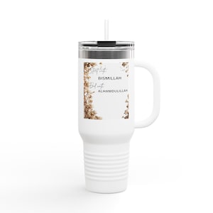 May include: White travel mug with a handle and a straw. The mug features the text "Start with BISMILLAH End with ALHAMDULILLAH" on a white label, framed by a floral design. The mug has a silver lid and a white handle.