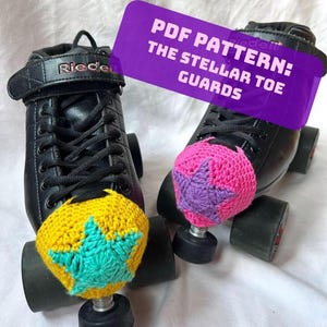 May include: Black roller skates with colorful, crocheted toe guards. One guard is yellow with a teal star, the other is pink with a purple star. The image includes a purple sign that reads "PDF PATTERN: THE STELLAR TOE GUARDS."