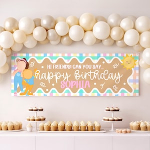 May include: A rectangular birthday banner featuring a tan wavy center with the text "HI FRIENDS! CAN YOU SAY... happy Birthday SOPHIA" in white and pink. The banner has a pastel plaid border, a cartoon character, and a yellow sun graphic.