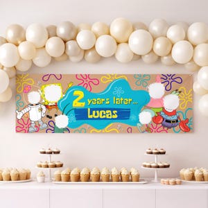 May include: A rectangular party banner featuring SpongeBob SquarePants characters with blank white circular face cutouts, the text 2 years later... Lucas, and a tan background with colorful floral patterns, framed by a large arch of white balloons.