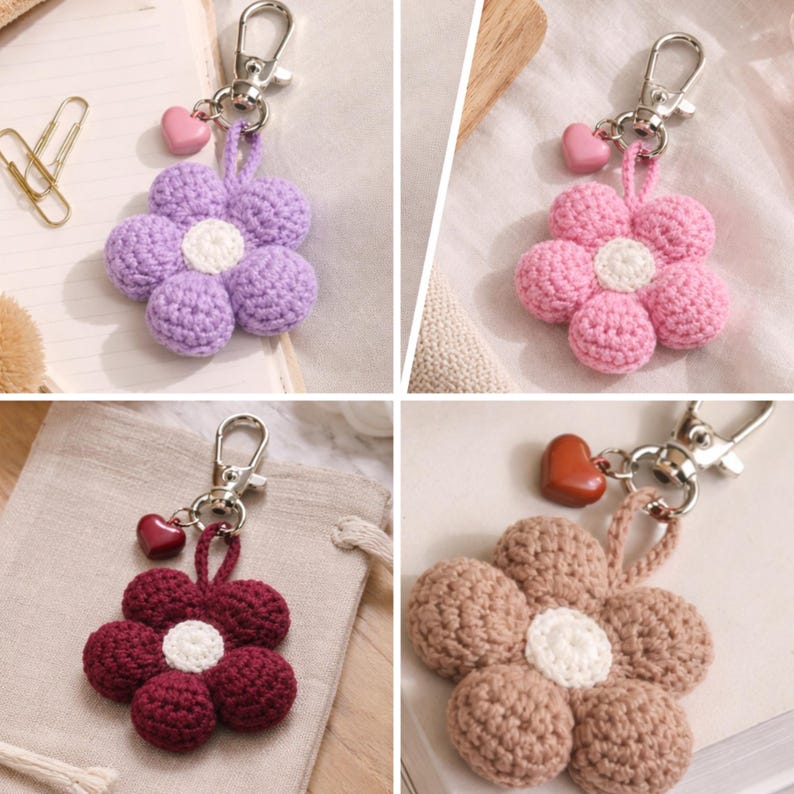 May include: Four crochet flower keyrings in shades of purple, pink, burgundy, and tan. Each flower features a white centre and a small heart charm. The keyrings have silver-coloured clasps.
