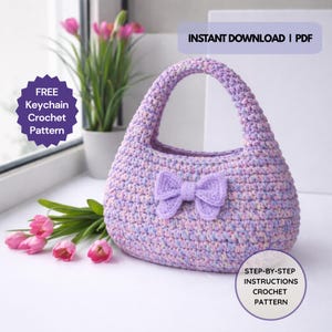 May include: A handmade crochet handbag in shades of lavender, pink, and blue, featuring a bow detail. The bag has a rounded shape with a handle. Text on the image reads "INSTANT DOWNLOAD | PDF", "FREE Keychain Crochet Pattern", and "STEP-BY-STEP INSTRUCTIONS CROCHET PATTERN".