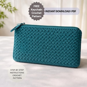 May include: Teal crochet clutch with a zipper closure. The rectangular pouch features a textured stitch pattern. Text on the image reads "FREE Keychain Crochet Pattern" and "INSTANT DOWNLOAD | PDF". Also, "STEP-BY-STEP INSTRUCTIONS CROCHET PATTERN".