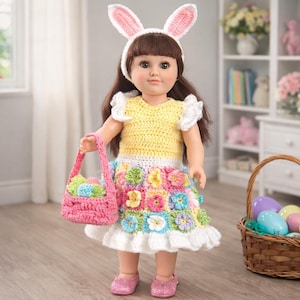 May include: A doll wearing a yellow crochet top, a skirt adorned with colorful crochet flowers, and a white ruffled hem. The doll has a pink basket filled with colorful eggs and wears a bunny ear headband. The doll is wearing pink glitter shoes.