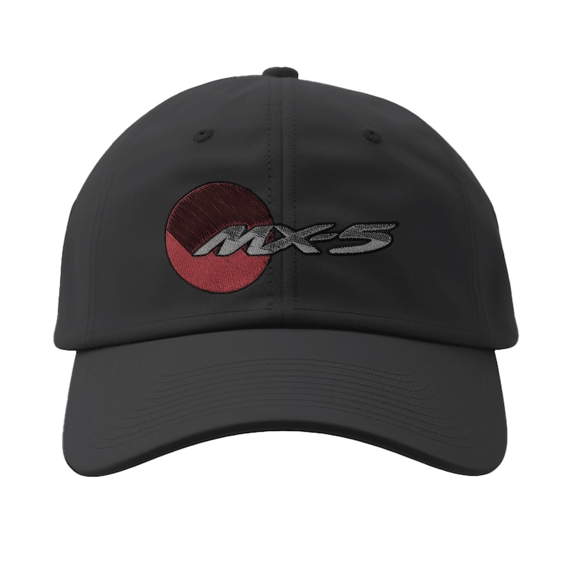 May include: Black baseball cap with a curved brim. The cap features an embroidered design of a red and gray circle with the text "MX-5" in gray. The cap is made of a durable fabric and has a structured fit.