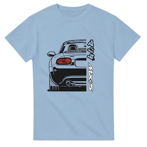 Può includere: T-shirt azzurra con un'illustrazione in bianco e nero della parte posteriore di un'auto, con la scritta "MX-5" in bianco. I fanali posteriori dell'auto sono rossi. La maglietta è di colore azzurro unito.