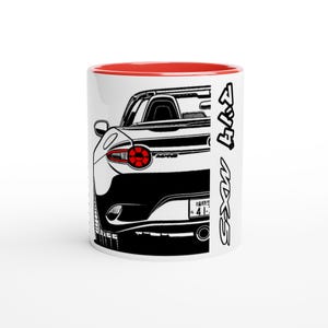 May include: White ceramic mug with a red interior featuring a black and white illustration of a sports car's rear view. The car's taillight is red. The text "MX-5" is printed vertically in Japanese characters.