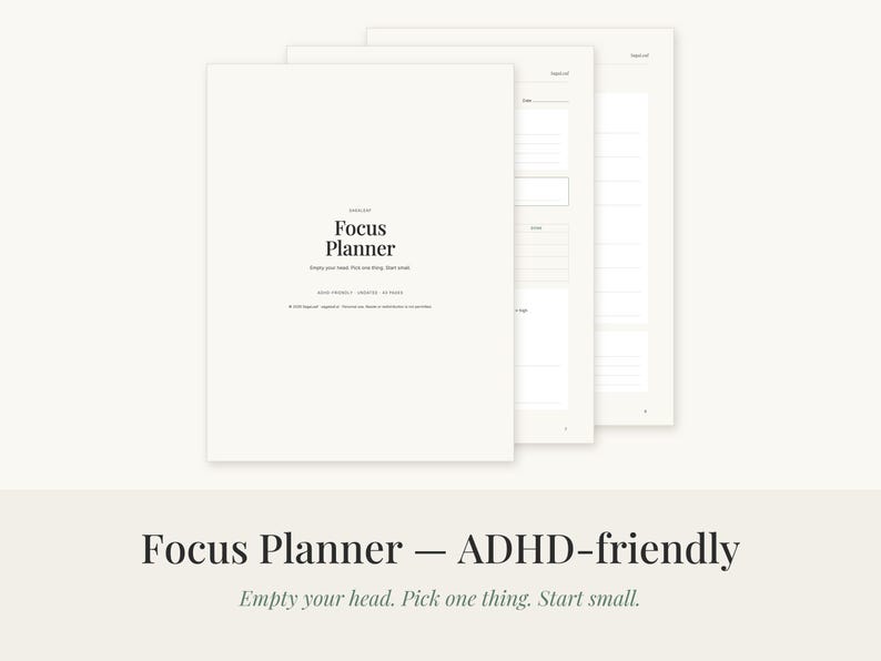 May include: A white Focus Planner with black text that reads Focus Planner, Empty your head. Pick one thing. Start small. The planner is shown with multiple pages stacked, revealing internal sections with lined spaces for notes and task tracking.