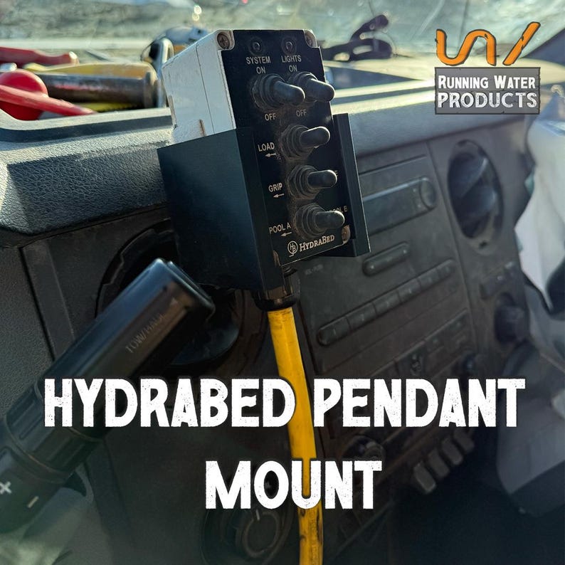 May include: A Hydrabed pendant mount with multiple toggle switches labeled "System", "Lights", "Load", "Grip", and "Pool A". The mount is black and white and is installed in a vehicle's dashboard. The text "Running Water Products" is visible.