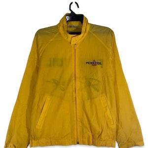 May include: A bright yellow Pennzoil jacket with a full zipper closure, two front pockets, and a stand-up collar. The Pennzoil logo is printed on the right chest. The jacket is hanging on a black hanger.