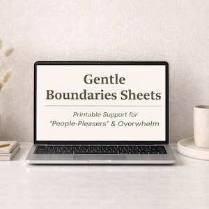 May include: A laptop displays the text "Gentle Boundaries Sheets" with the subtitle "Printable Support for 'People-Pleasers' & Overwhelm." The laptop is on a white surface, next to a mug, a vase with dried flowers, and a stack of books.