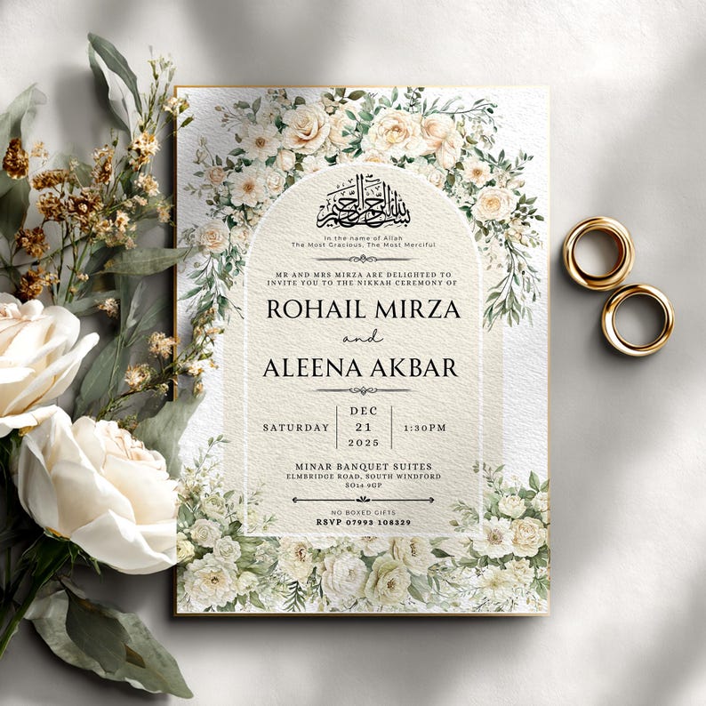 May include: Wedding invitation with floral accents and gold rings. The invitation features the names "ROHAIL MIRZA" and "ALEENA AKBAR", with the date "DEC 21 2025". The invitation is surrounded by white and cream-colored flowers.