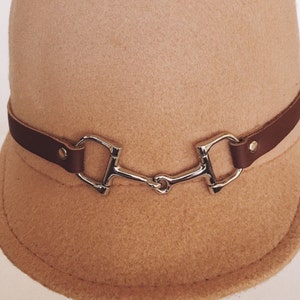 Equestrian cap with leather snaffle horse bit strap,British 1960s mod style