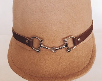 Equestrian cap with leather snaffle horse bit strap,British 1960s mod style