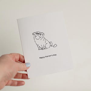 May include: A white greeting card featuring a black line drawing of a pug dog with a small cloud behind it. Below the illustration, the text reads "Happy Farter's Day" in a simple black font. The card has a textured surface and a folded edge.