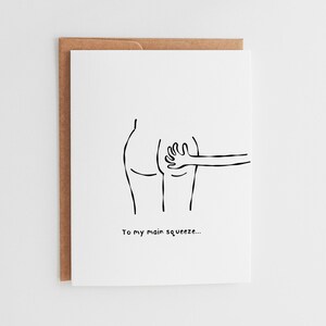 May include: A white greeting card with a brown envelope. The card features a black line drawing of a person's backside being patted by a hand. The text "To my main squeeze..." is below the illustration.