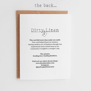 May include: A white greeting card with black text that reads: the back... Dirty Linen, This card did more than make you smile. Your card helped fund our mission: sharing random acts of kindness through tiny inspirational notes. The mission: Sending love, funding kindness. Find us at www.dirtylinenline.com and Instagram @JoyDropbyDirtyLinen.