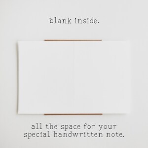 May include: A white greeting card opened to reveal a completely blank interior. The text "blank inside." is printed above the card, and the text "all the space for your special handwritten note." is printed below the card on a plain background.