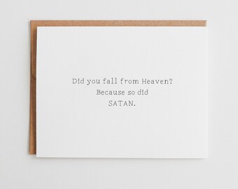 May include: A white greeting card with black typewriter-style text that reads: Did you fall from Heaven? Because so did SATAN. The card is placed on top of a brown kraft paper envelope, creating a simple and direct visual presentation of the message.