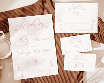 May include: A set of baby shower invitations with a pink bow design. The invitations include a main invitation, RSVP card, diaper raffle card, and baby registry card. The text on the main invitation reads "Please join us for a Baby Shower in honor of Felicity Harrison, March 12, 12 PM, [address]".
