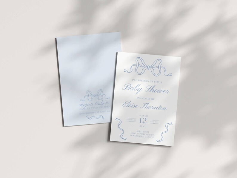 May include: A white baby shower invitation with blue ribbon designs. The invitation reads "Please join us for a Baby Shower in honor of Eloise Thornton" with the date and time of the event.