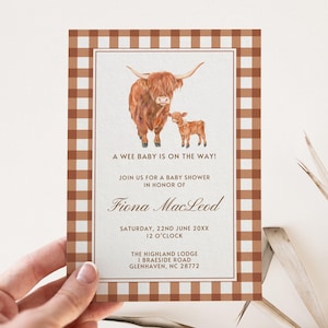 May include: A baby shower invitation with a brown and white gingham pattern. The invitation features a watercolor illustration of a Highland cow and calf. The text reads "A wee baby is on the way! Join us for a baby shower in honor of Fiona MacLeod. Saturday, 22nd June 20XX, 12 o'clock. The Highland Lodge, 1 Braeside Road, Glenhaven, NC 28772."