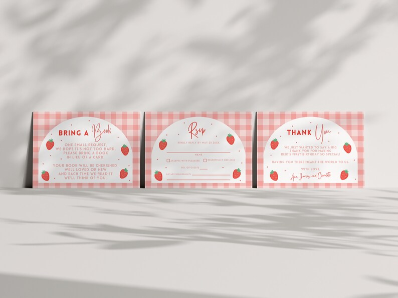May include: Three pink and white gingham patterned cards with a strawberry theme. The first card says "Bring a Book" and has a red arch with the text "One small request, we hope it's not too hard, please bring a book in lieu of a card. Your book will be cherished well loved or new and each time we read it we'll think of you." The second card says "RSVP" and has a red arch with the text "Kindly RSVP by May 1st, 2023." The third card says "Thank You" and has a red arch with the text "We just wanted to say a big thank you for making Reid's first birthday so special. Having you there meant the world to us. With love, Jay, Jenny and Charlotte."