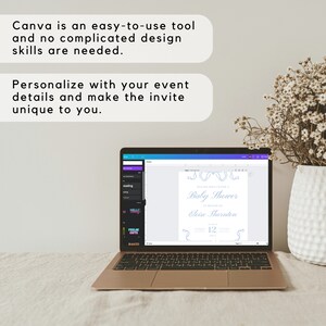 May include: A laptop computer screen displaying a Canva design template for a baby shower invitation. The template features a blue and white color scheme with a decorative border and the text "Please join us for a Baby Shower in honor of Eloise Thornton".
