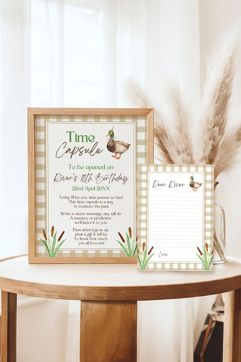 May include: A printable time capsule for an 18th birthday. The design features a brown and green duck with a green hat, green reeds, and a brown and white gingham background. The text reads "Time Capsule To be opened on River's 18th Birthday 22nd April 20XX Today I'll be one, time passes so fast! This time capsule is a way to treasure the past. Write a sweet message, any will do. A memory or prediction we'll leave it to you. Then when I grow up, what a gift it will be. To know how much you all love me!"