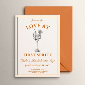 May include: A white card with orange text that reads "Join us for LOVE AT FIRST SPRITZ Nikki's Bachelorette Trip JUNE 22ND-24TH 20XX PALM TREE INN 456 ORANGE BOULEVARD, MIAMI, FL 29403". A black and white illustration of a glass of orange juice with a slice of orange and a straw is in the center of the card.