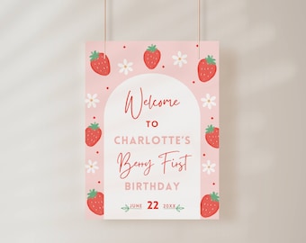 May include: A pink welcome sign with a strawberry theme. The sign says "Welcome to Charlotte's Berry First Birthday June 22 20XX".