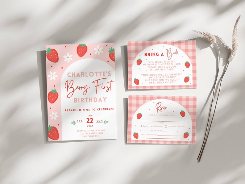 May include: A pink and white invitation with a strawberry theme for a first birthday party. The invitation says "Charlotte's Berry First Birthday" and includes the date, time, and location of the party. It also includes a request to bring a book in lieu of a card. The invitation is accompanied by a pink and white RSVP card with a strawberry design.
