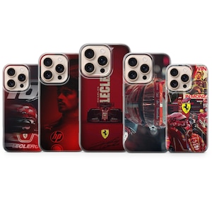 May include: A collection of five phone cases featuring Ferrari racing themes. The cases display images of race cars, drivers, and the Ferrari logo in red, black, and white. Each case has a clear border.
