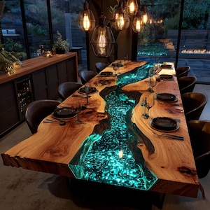 May include: A large, handcrafted wooden dining table with a river of glowing blue resin running through the center. The table is surrounded by black chairs and set with plates and glasses. Overhead, several pendant lights illuminate the scene.