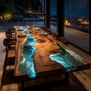 May include: A large, custom-made dining table with a live edge design. The table features a river of blue resin flowing through the center, creating a unique and artistic look. The table is surrounded by wooden chairs and set with plates and glasses.