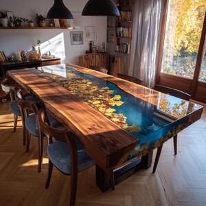 May include: A large, handcrafted dining table with a unique design. The table features a live edge wooden top with a river of blue resin inlaid with yellow leaves. The table is supported by a dark wooden base and surrounded by wooden chairs.