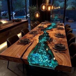 May include: A large, rectangular wooden dining table with a river-like design. The center is filled with glowing blue resin, resembling a flowing river. The table is set with plates, glasses, and silverware for a formal dinner. The table is approximately 120 inches long.