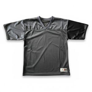 May include: A black football jersey with a V-neck collar. The jersey features a mesh body and solid black shoulders and sleeves. A small tag is visible near the bottom hem.