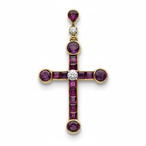May include: A gold-toned cross pendant featuring a central diamond and surrounding purple gemstones. The cross has a teardrop-shaped purple gemstone at the top and circular purple gemstones at the ends of the cross.