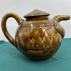 May include: A set of three ceramic mugs with a speckled, matte finish. The mugs are in shades of cream, light gray, and dark gray. Each mug has a simple, minimalist design, perfect for coffee or tea.