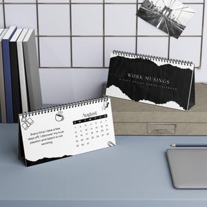 May include: Two spiral-bound desk calendars with black and white designs. One displays the title Work Musings, A 2024 Office Humor Calendar. The other shows the month of August with the text, Every time I take a few days off, I discover my true passion and talent is not working.